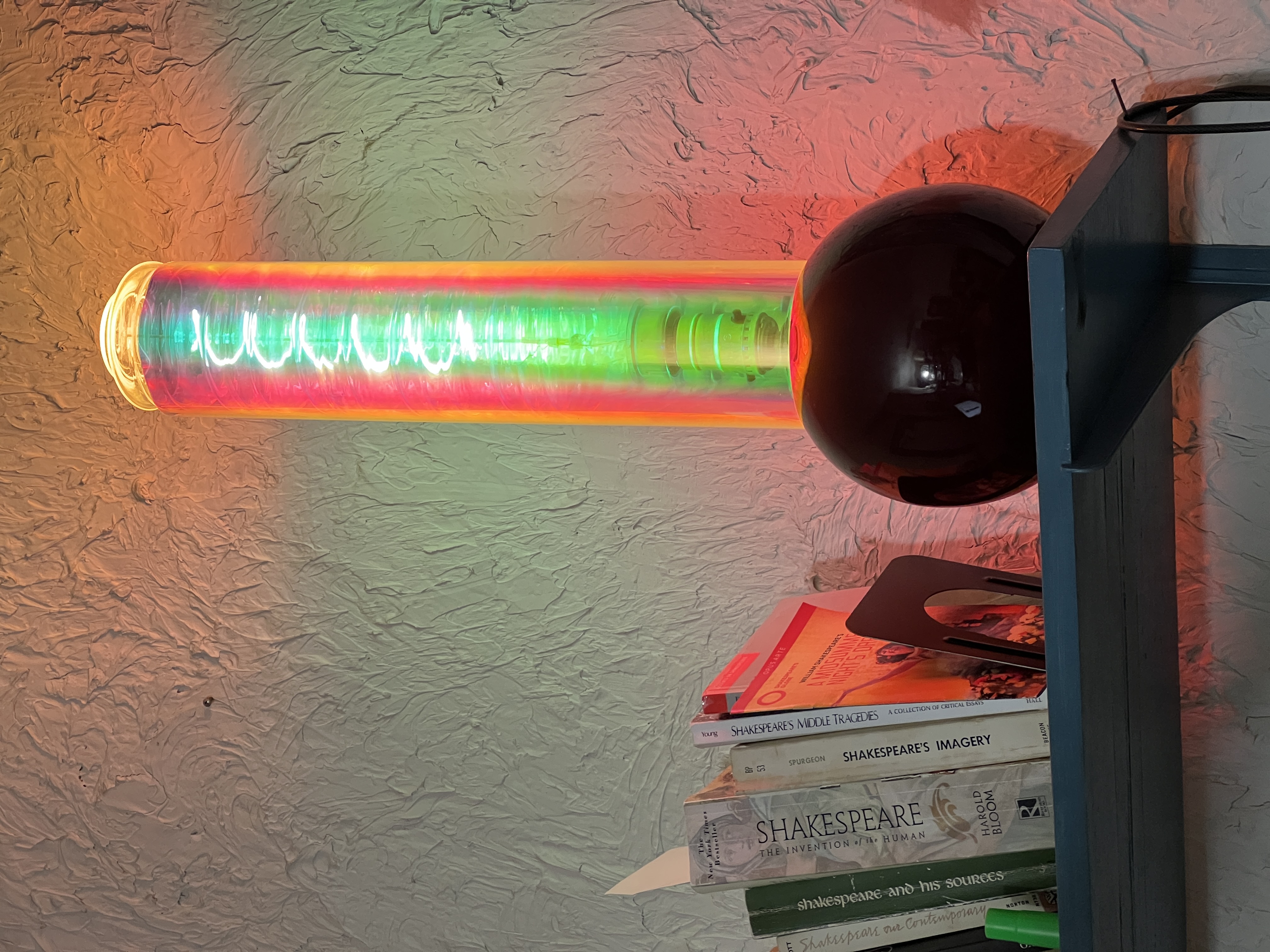 Red and green neon tube with dark globe base
