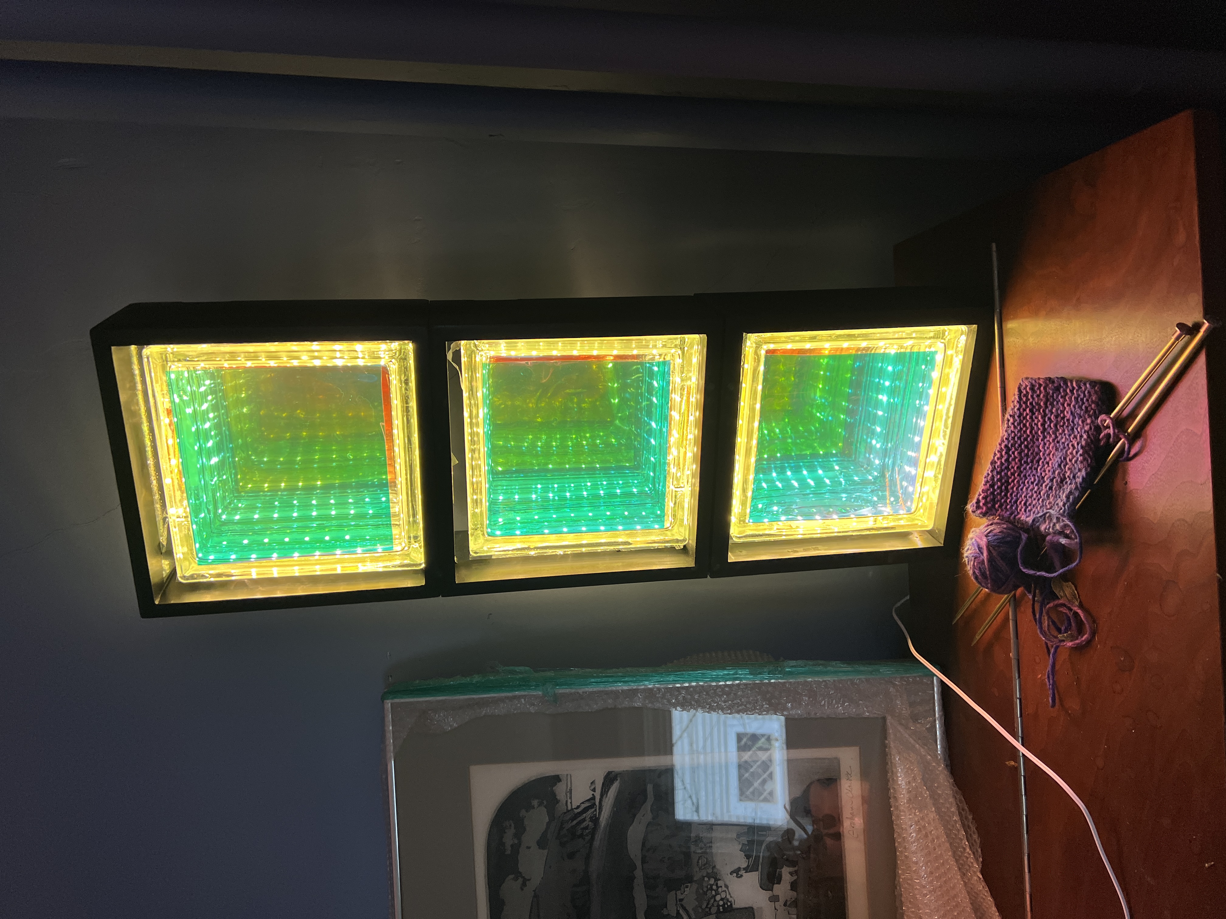 Three stacked infinity-mirror boxes