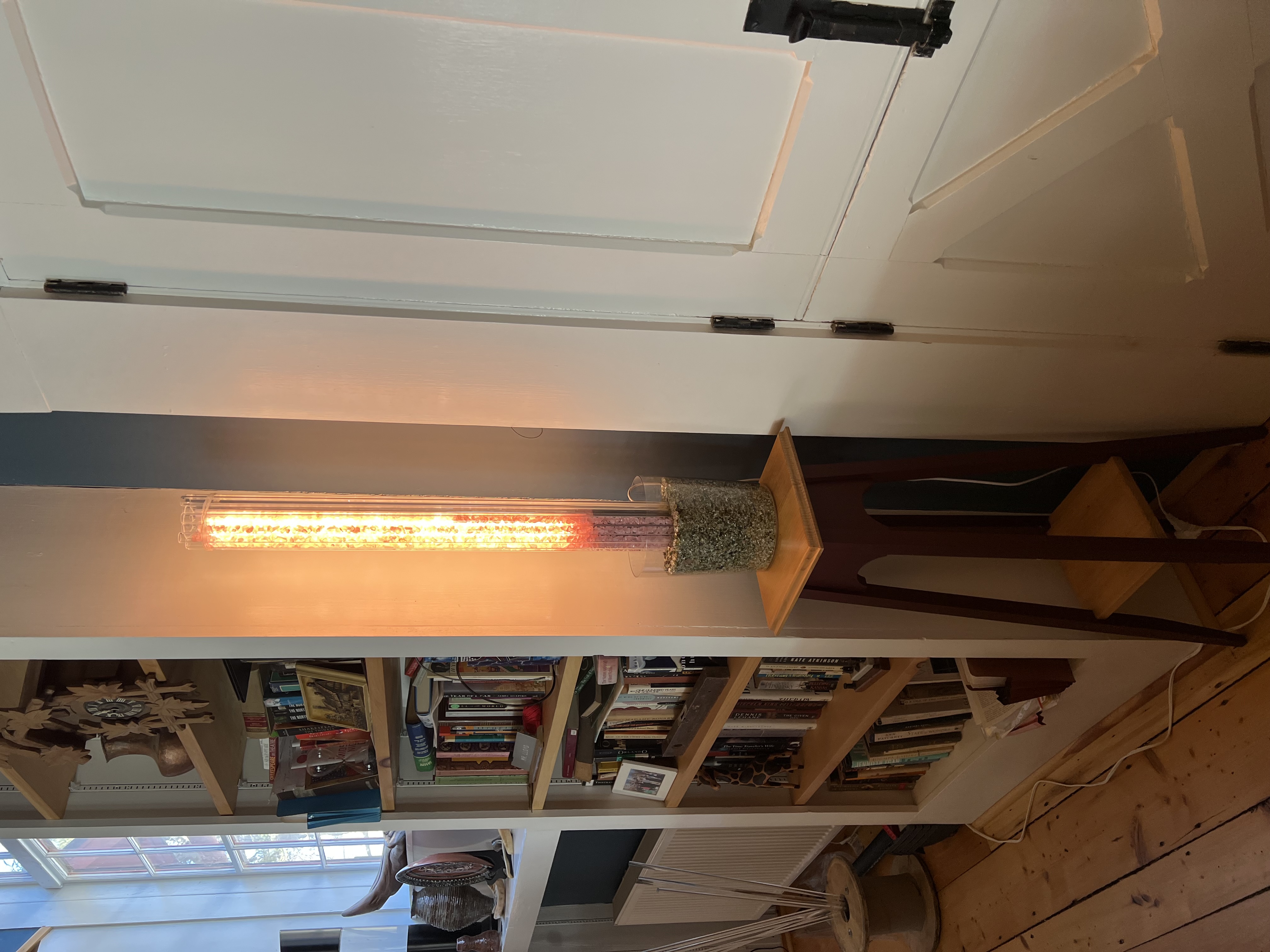 Tall orange glowing tube on pedestal