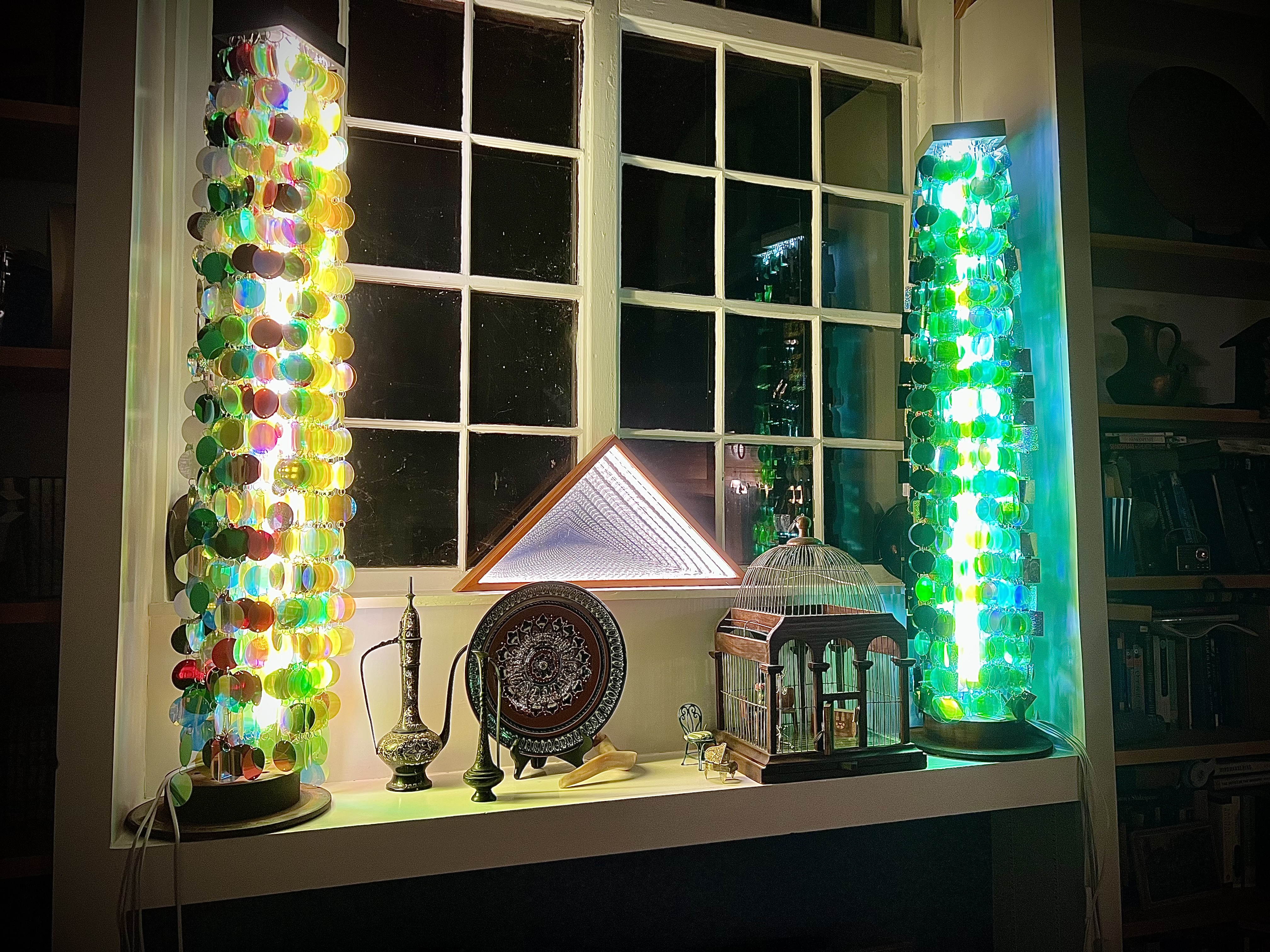 Colored disc towers in window with decorative objects